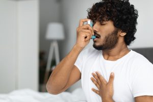 Man suffering from asthma because the presence of mold in his home.